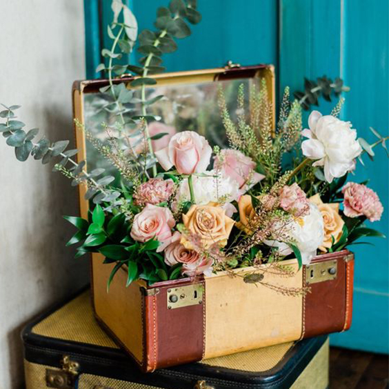 Mala decorativa com flores para um chá de panela no estilo vintage