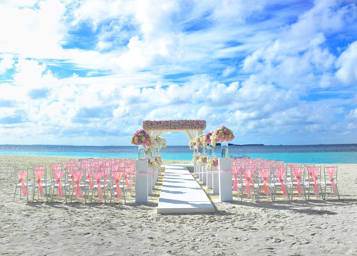 Cadeiras e altar florido rosa na praia