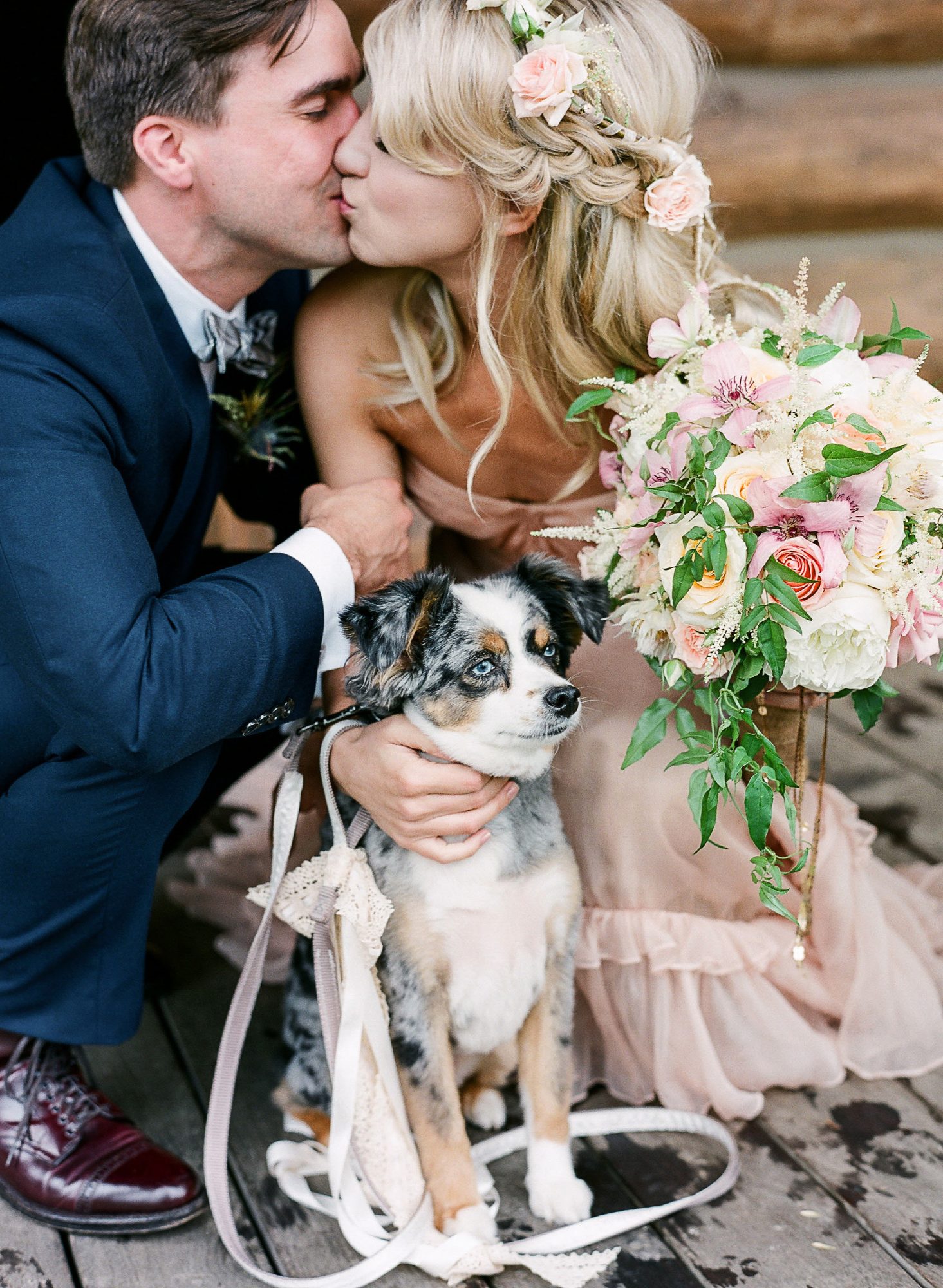noivos se beijando com cachorro em casamento
