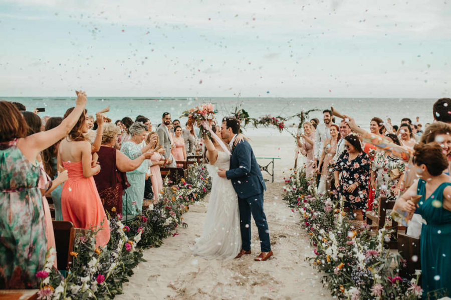 saida dos noivos se beijando em destination wedding na praia