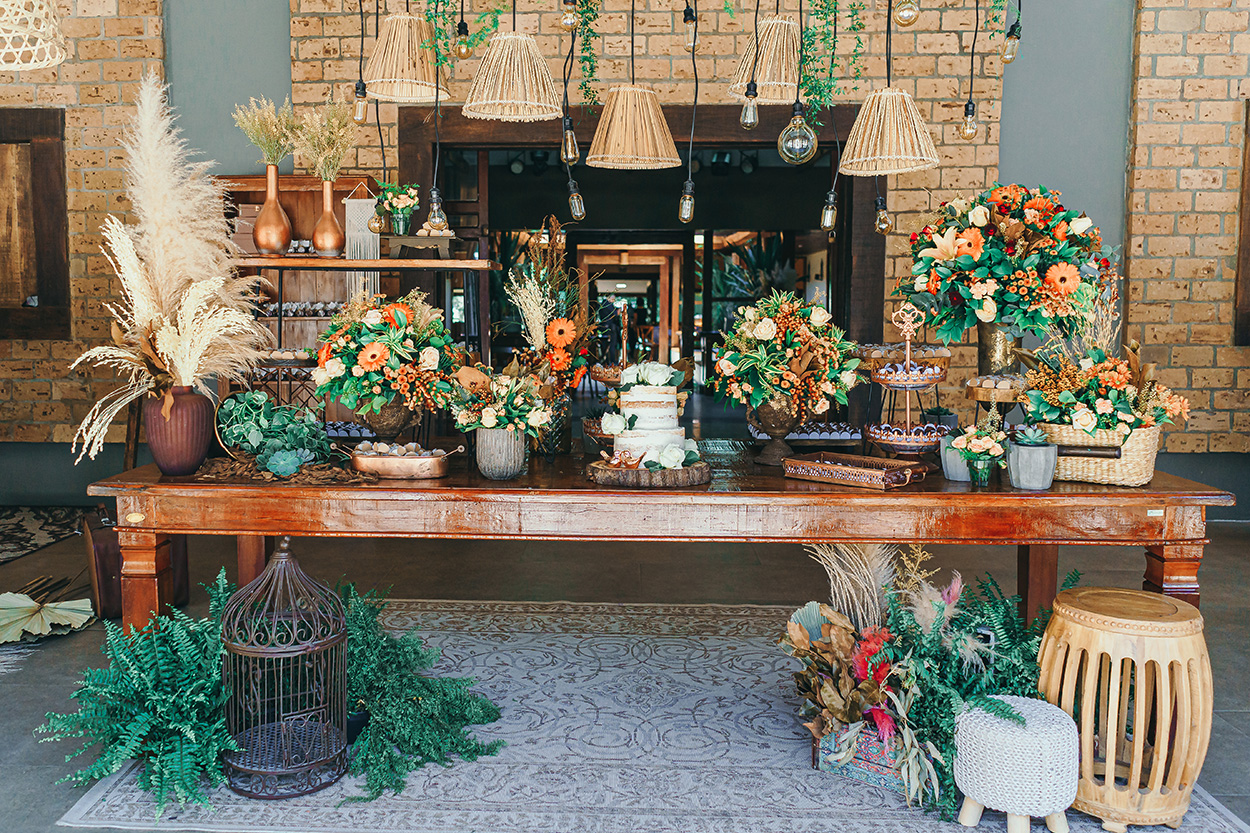 Mesa com bolo de casamento e flores