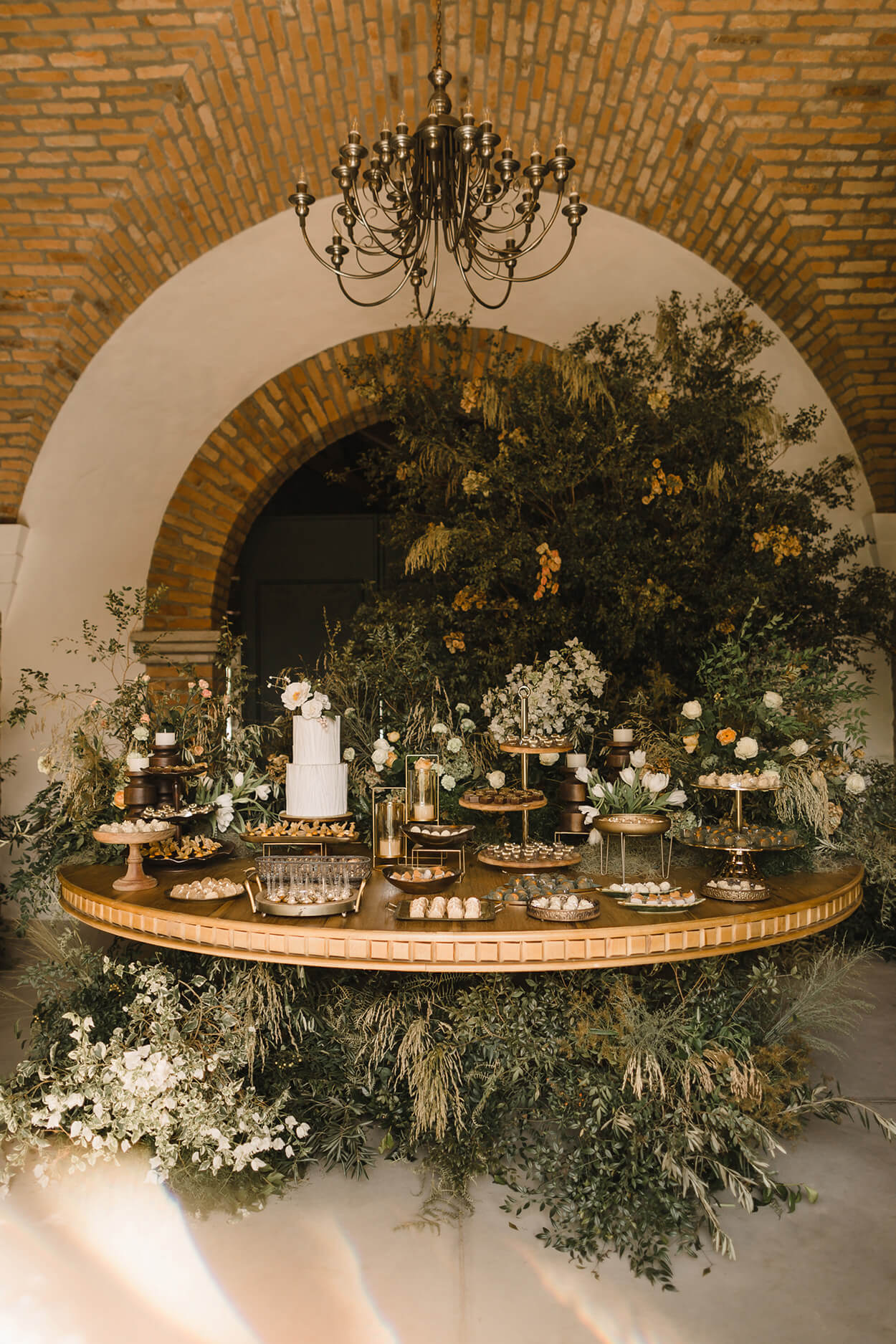 Salão com mesa redonda e bolo de casamento