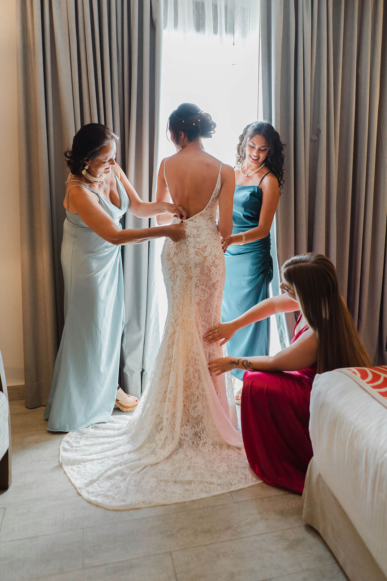 Mulheres arrumando o vestido da noiva