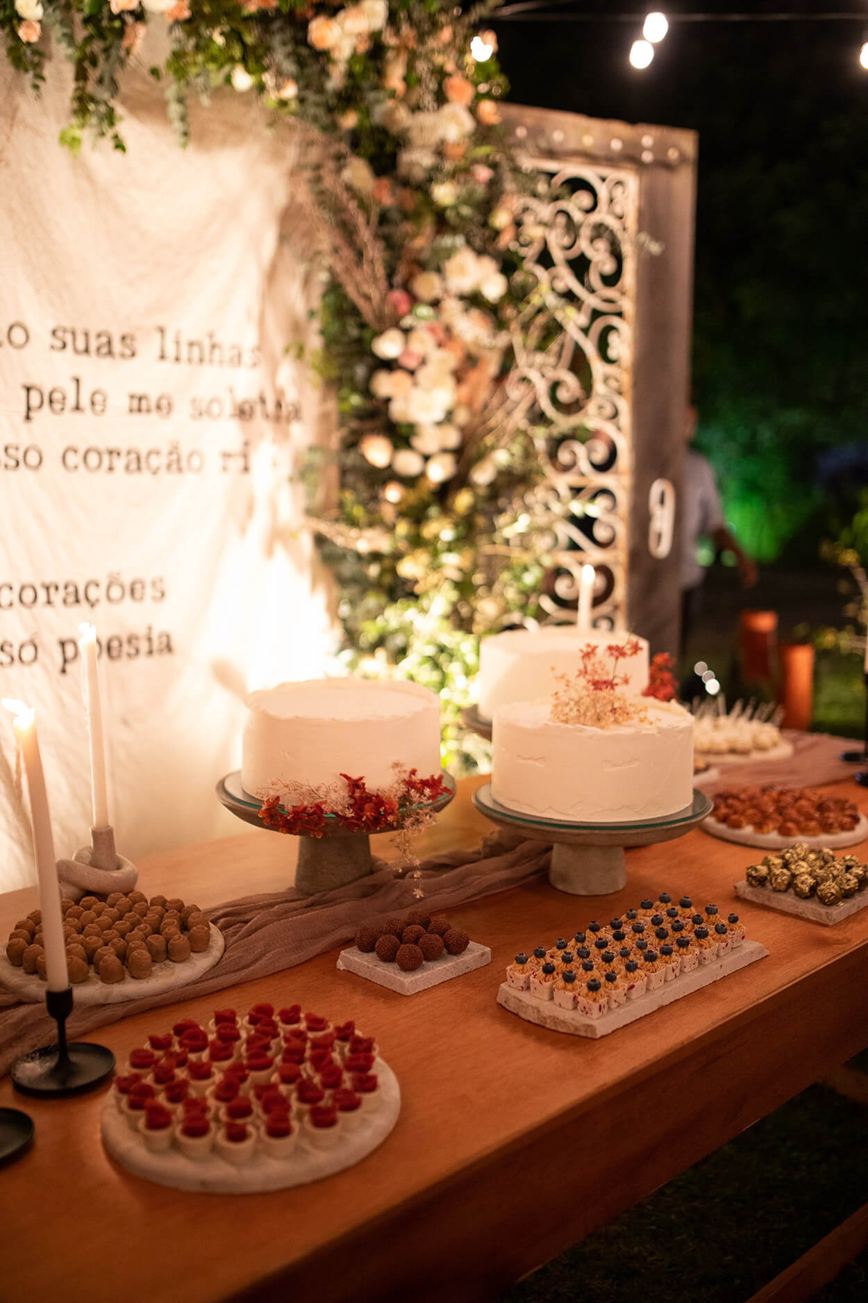 Mesa com bolo de casamento e doces