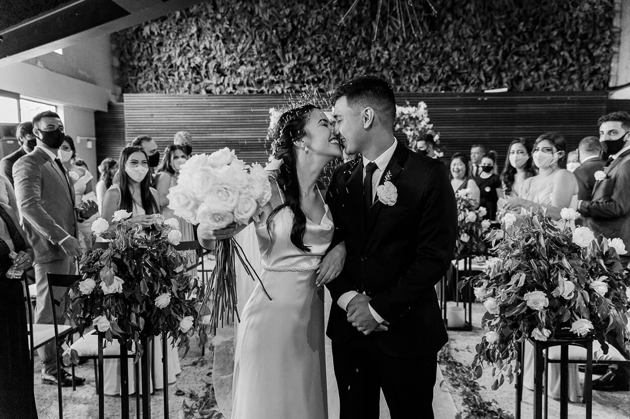 Foto em preto e branco dos noivos se beijando