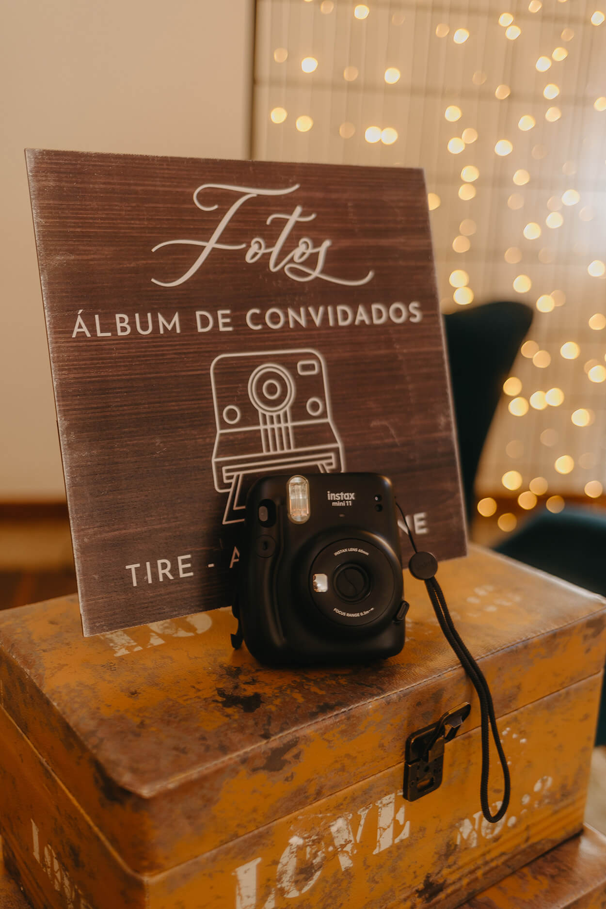 Placa de madeira escrito fotos álbum de convidados e câmera instantânea preta a frente