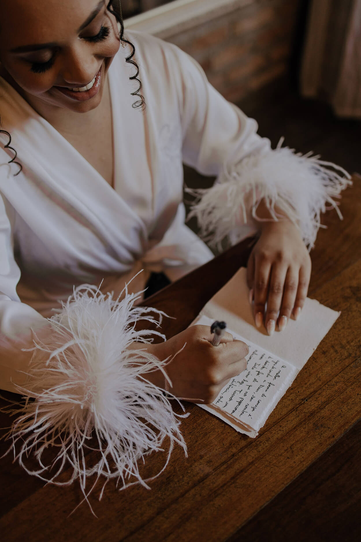 Noiva com robe escrevendo no caderno de votos