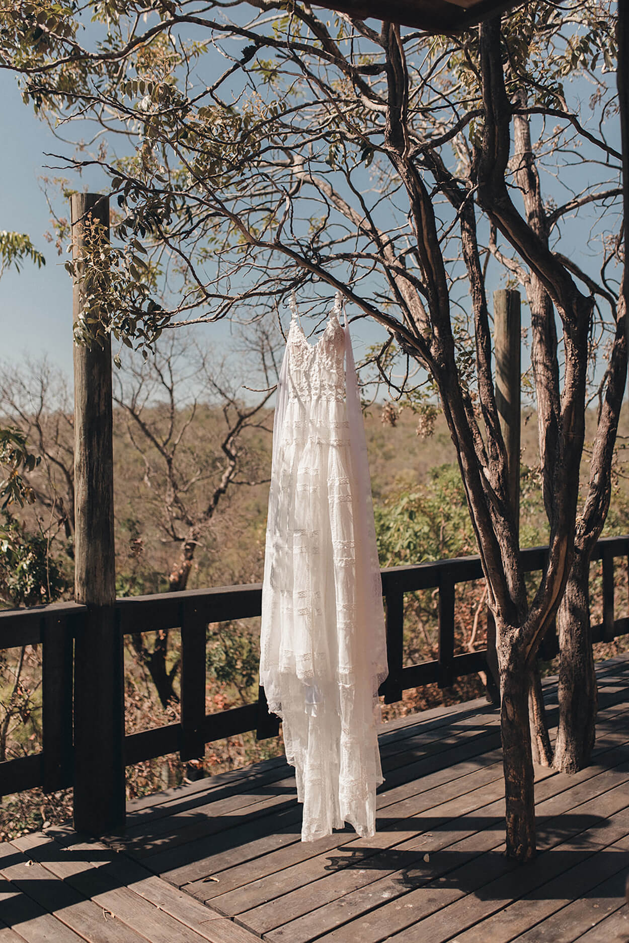 vestido de noiva com alças pendurado na arvore