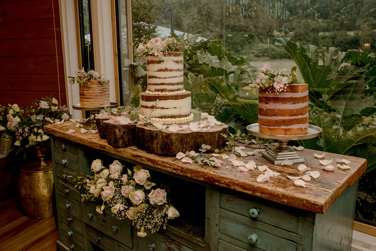 mesa rústica com três bolos de casamento espatulados