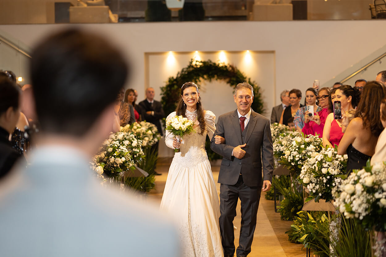 entrada da noiva com o pai vestindo terno cinza
