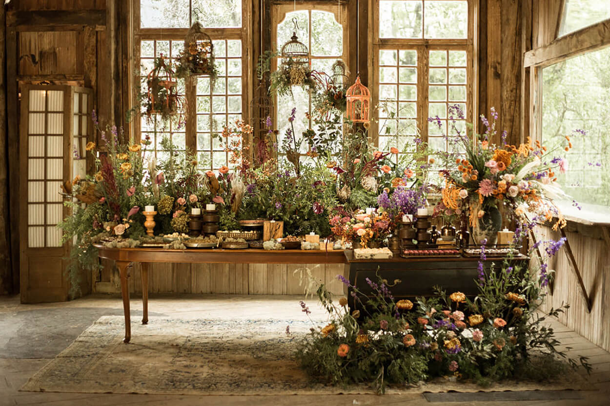 salão rústico com mesa de madeira com velas e plantas