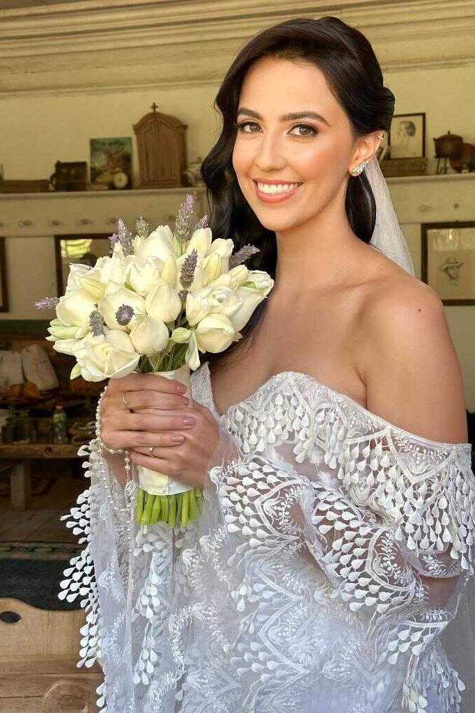 noiva com vetsido borado segurando buquê cim flores brancas e lavanda