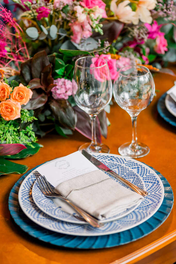 mesa posta com sousplat azul prato decorado e guardanapo branco