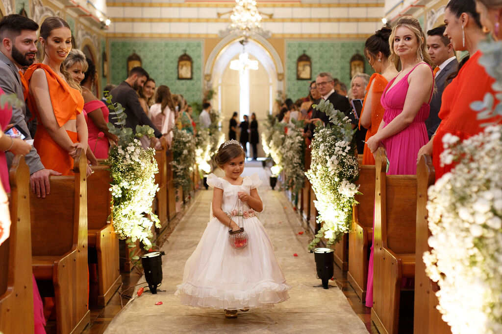 entrada da daminha jogando pétalas de flores rosas na igreja