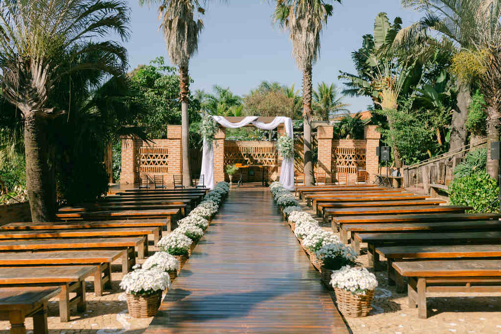altar para casamento com tecido branco com arranjos florais