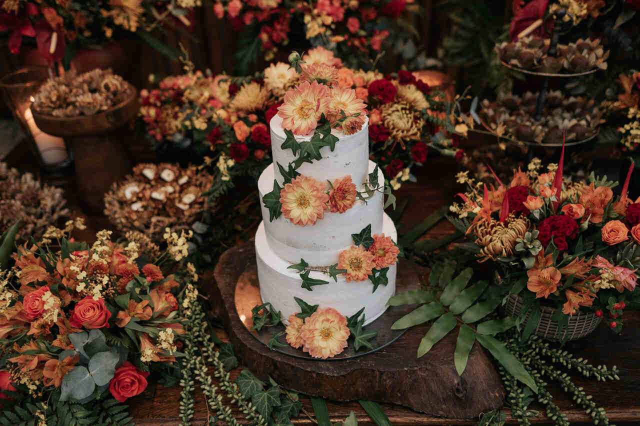 visão de cima de bolo de casamento branco com flores terracota