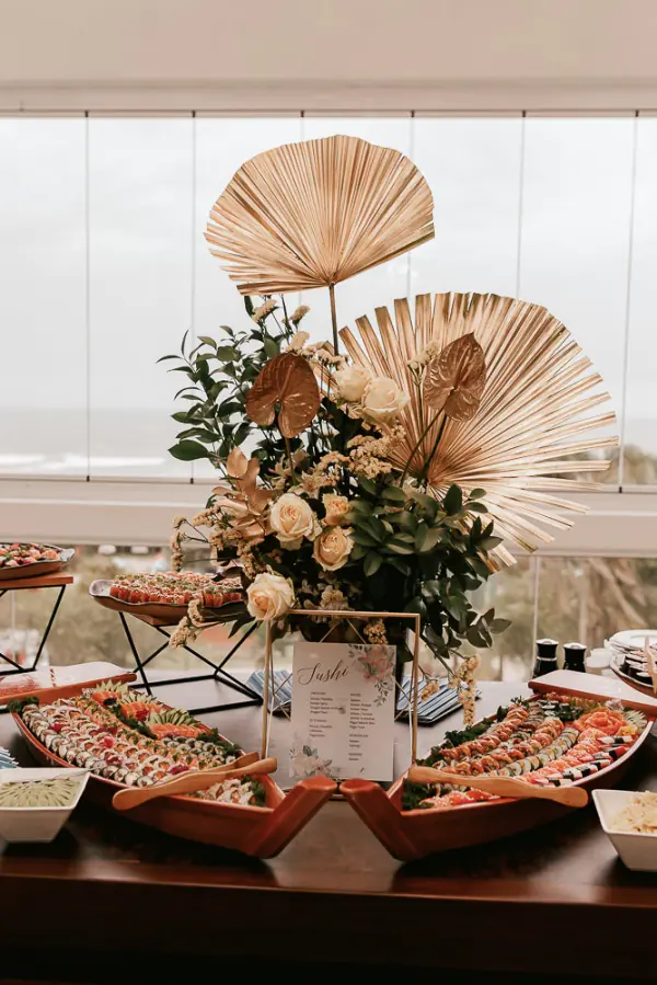 Mesa de casamento com barcas de comida japonesa