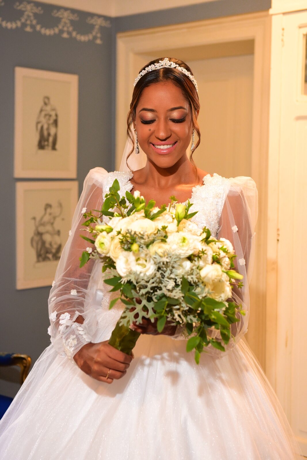 noiva com tiara segurando buquê com flores brancas