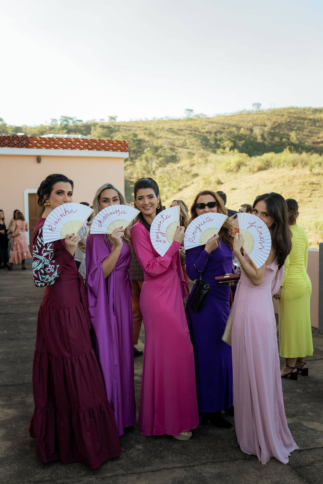 madrinhas com vestidos coloridos com leques