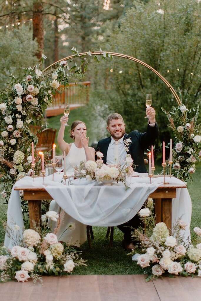 casal brindando na mesa dos noivos