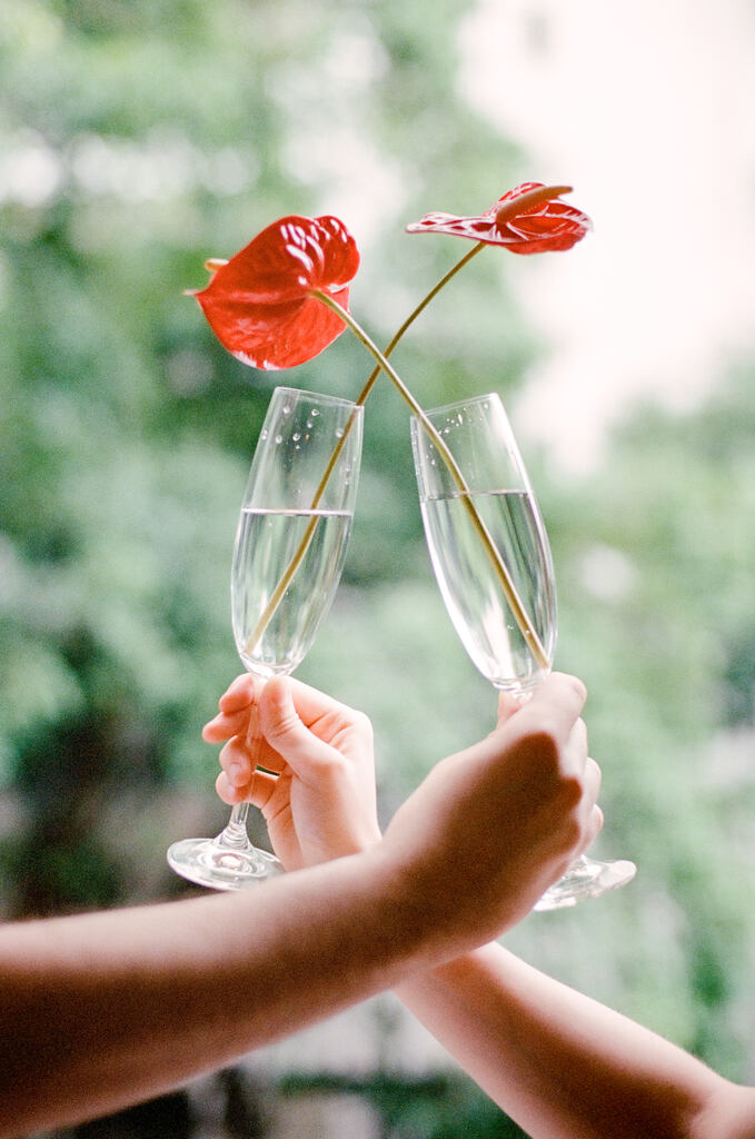 casal brindando com taça com flor