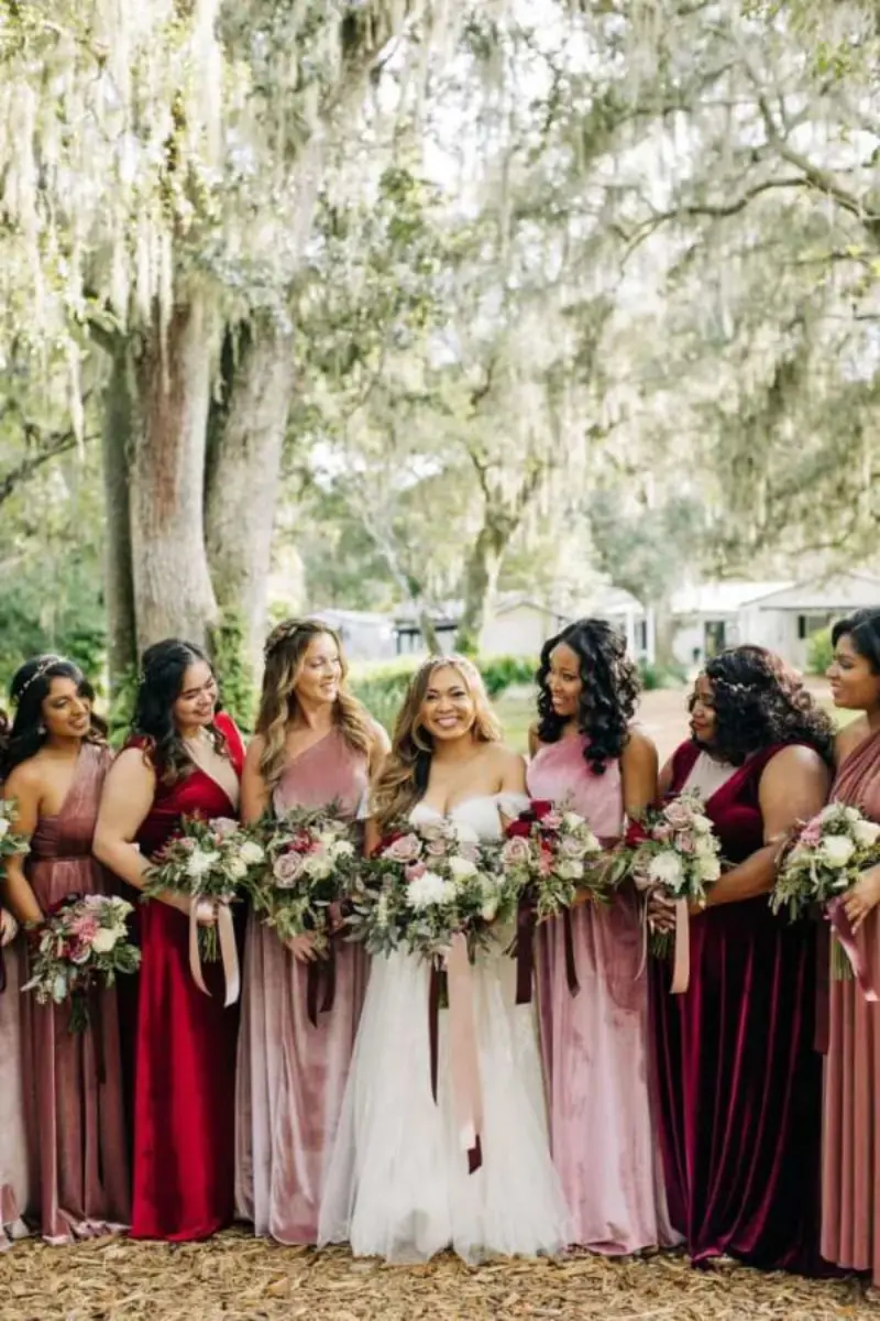 madrinhas com vestidos em tons de marsala e rosa seco, acompanhando a noiva.