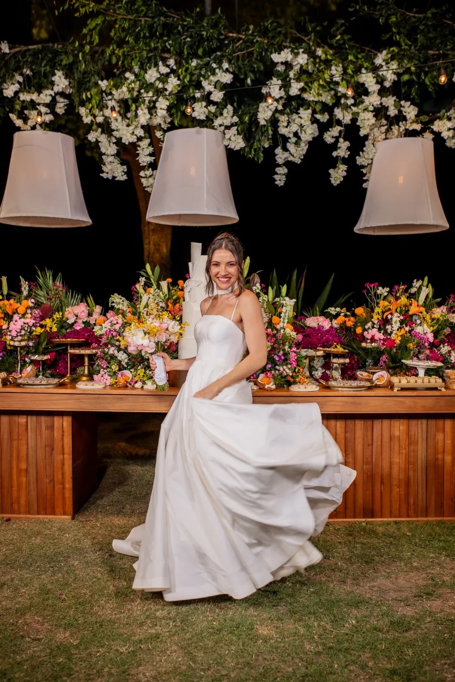 noiva na frente da mesa do bolo