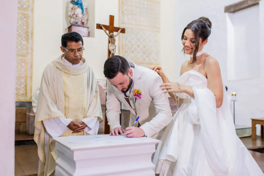 noivos assinando papeis do casamento 