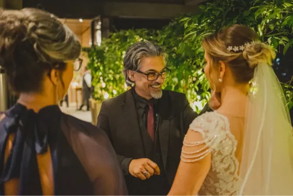 capa post: DH2 Eventos Sociais sorrindo para noiva antes da entrada dela