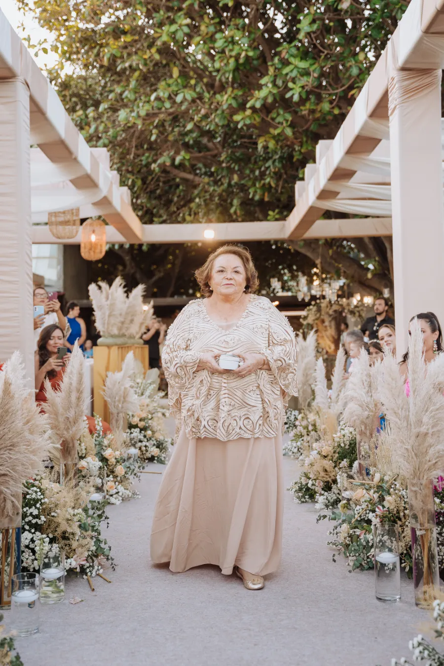 avó da noiva com vestido bege levando alianças