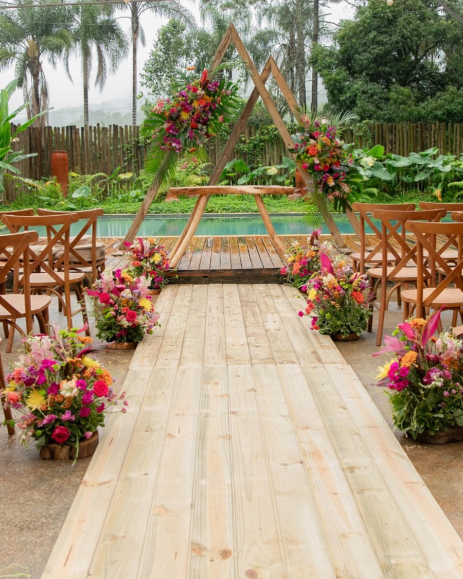 altar de casamento em frente a piscina e decorado com flores