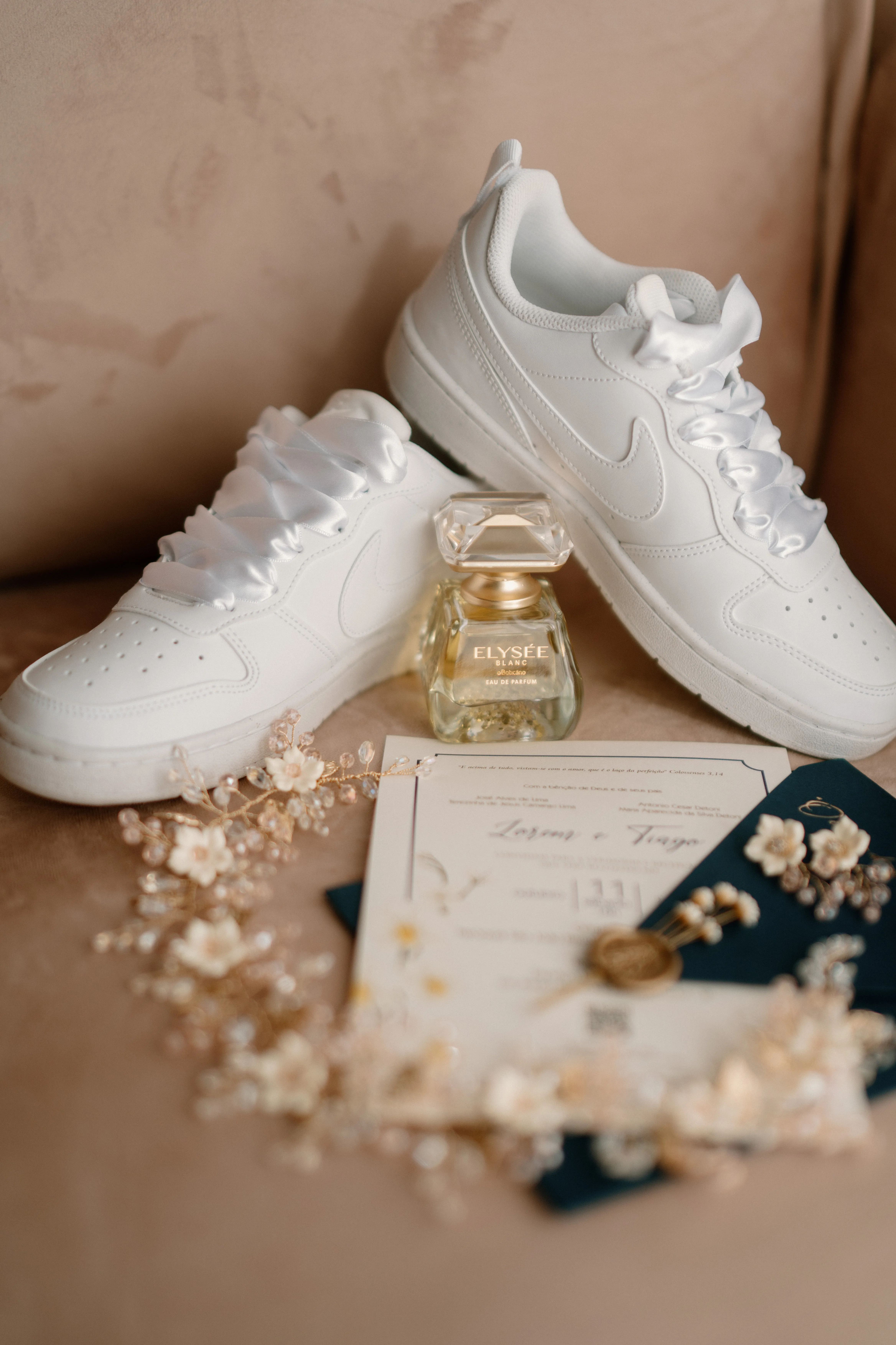 tenis de noiva ao lado de perfume e convite