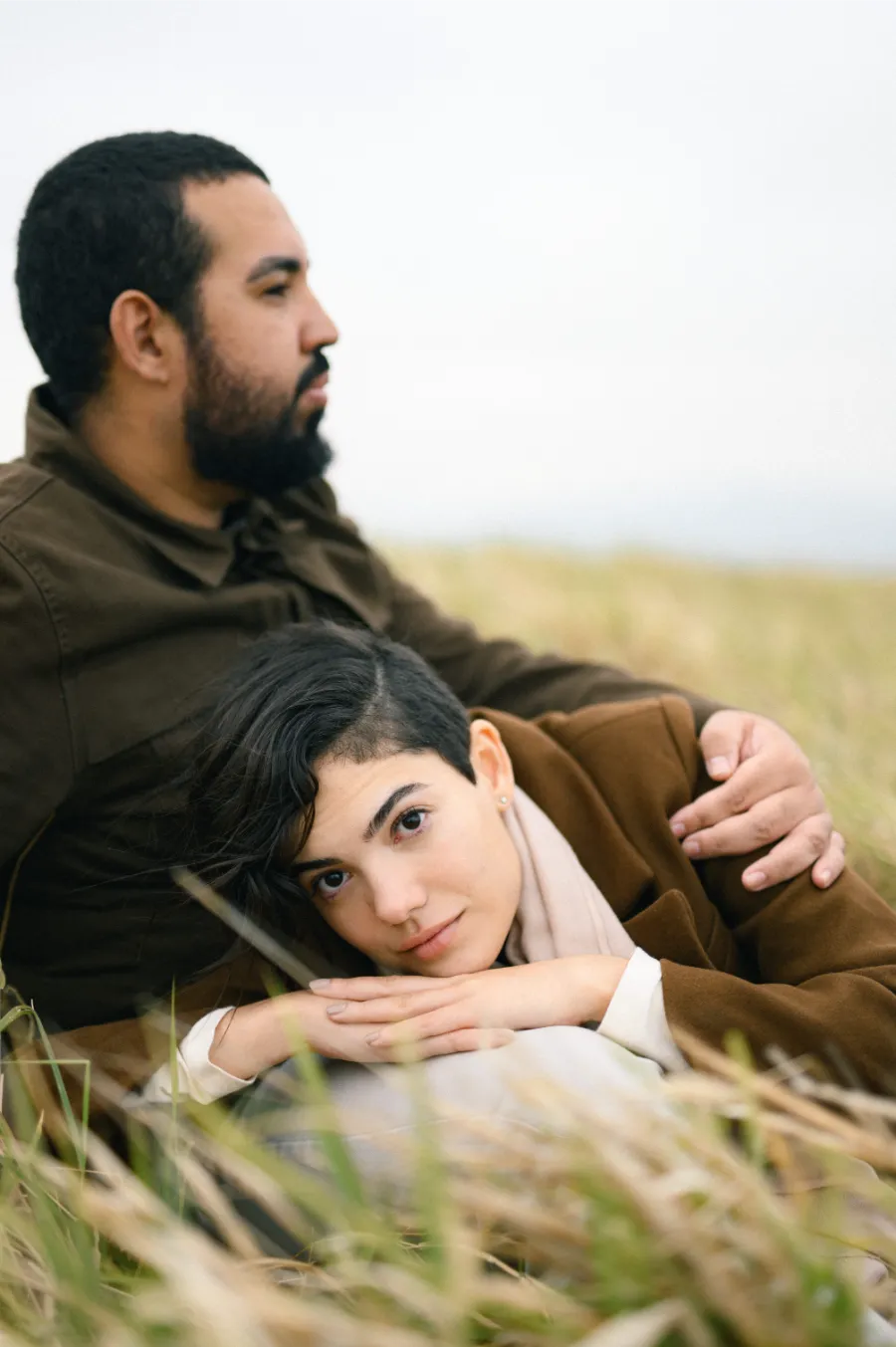 noiva sentada no colo do noivo no pre wedding no campo